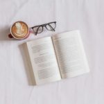 book near eyeglasses and cappuccino